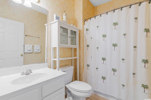 bathroom featuring tile patterned floors, vanity, and toilet