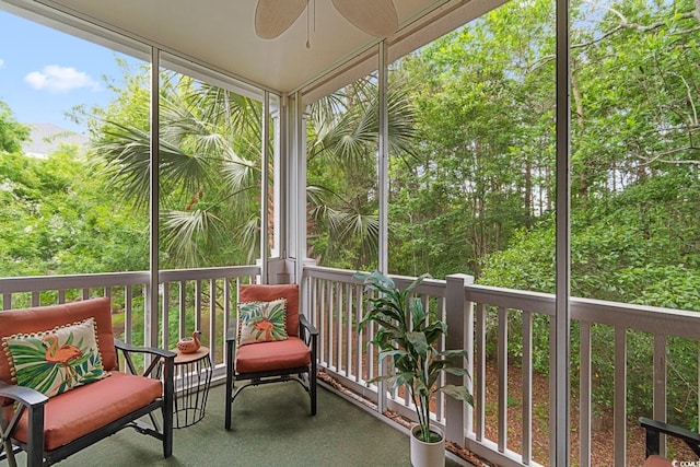 unfurnished sunroom with ceiling fan