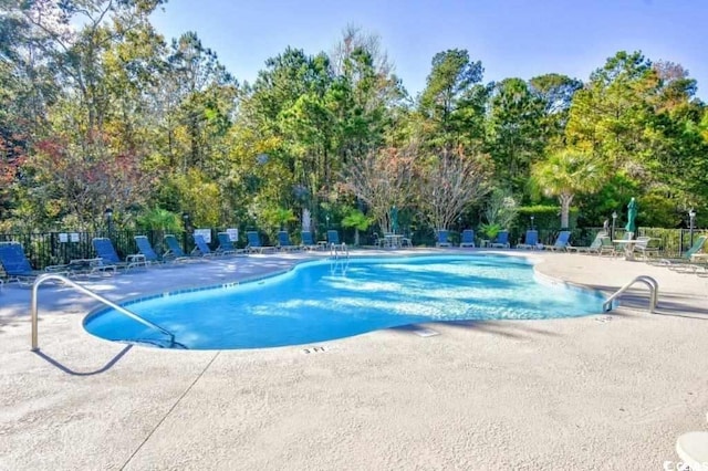 view of swimming pool featuring a patio area