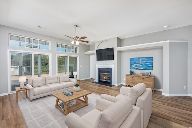 living room featuring ceiling fan and wood-type flooring