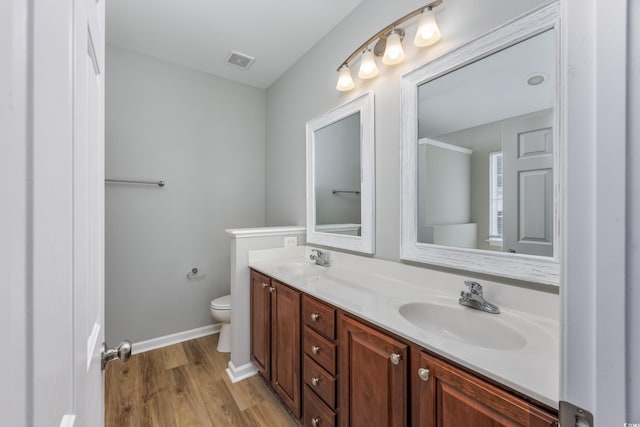 bathroom featuring hardwood / wood-style flooring, vanity, and toilet