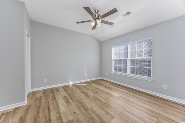 unfurnished room featuring ceiling fan, light hardwood / wood-style floors, and vaulted ceiling