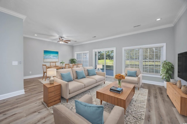 living room with ceiling fan, crown molding, and light hardwood / wood-style floors