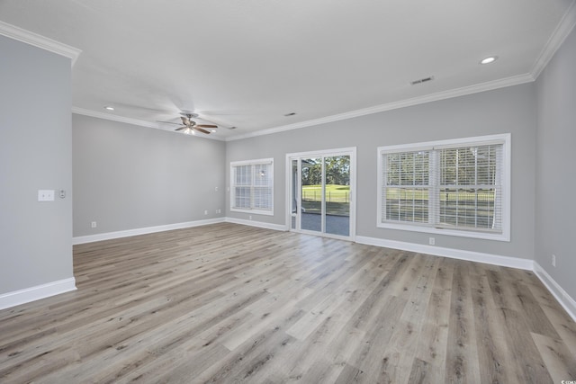 spare room featuring light hardwood / wood-style floors, ceiling fan, and crown molding