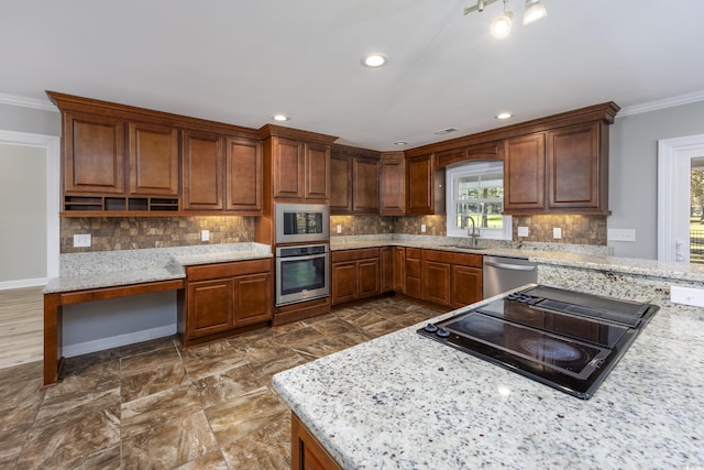 kitchen featuring stainless steel appliances, light stone counters, ornamental molding, and sink