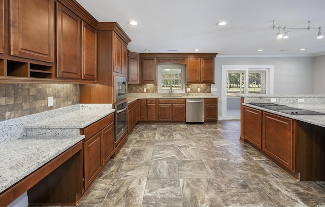 kitchen with sink, stainless steel appliances, light stone counters, backsplash, and ornamental molding