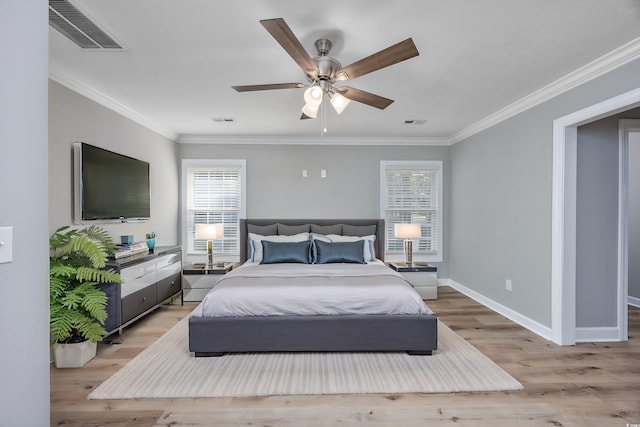 bedroom featuring ceiling fan, crown molding, and light hardwood / wood-style flooring