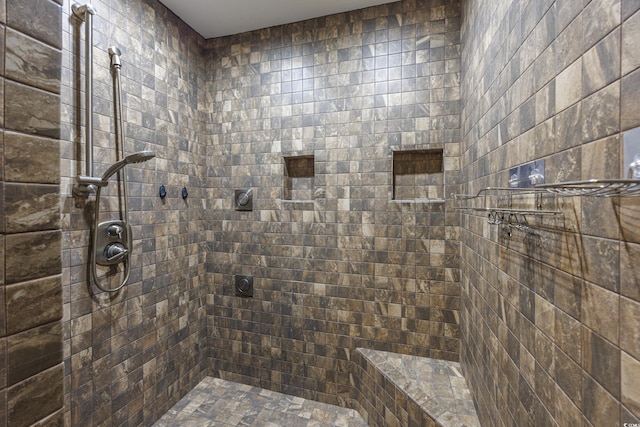 bathroom with a tile shower