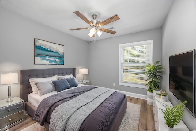 bedroom with ceiling fan and light hardwood / wood-style flooring