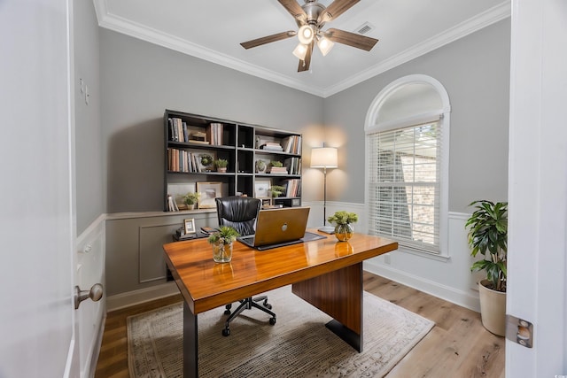 home office featuring light hardwood / wood-style flooring, ceiling fan, and crown molding