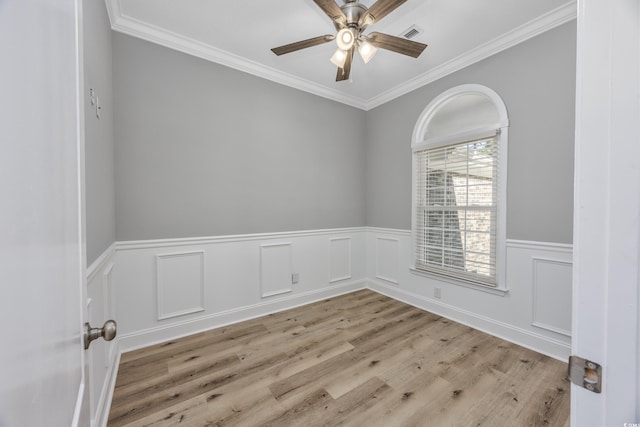 empty room with light hardwood / wood-style floors, ceiling fan, and crown molding