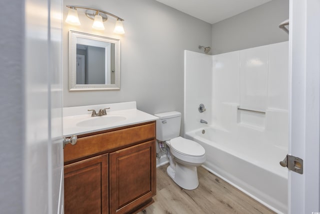 full bathroom with toilet, vanity, shower / bathtub combination, and hardwood / wood-style flooring