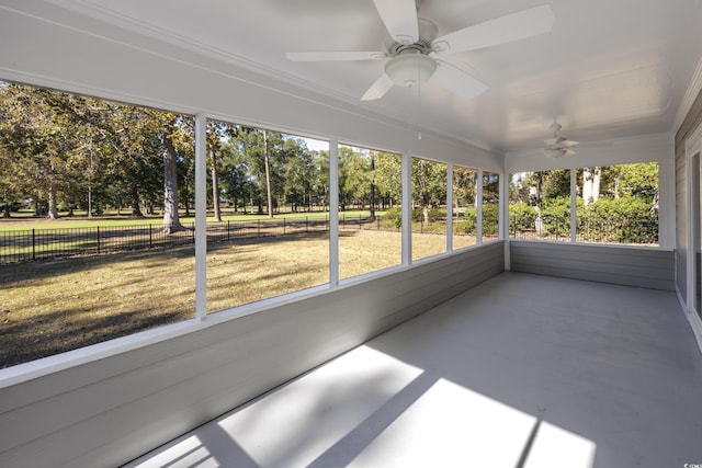 unfurnished sunroom featuring plenty of natural light and ceiling fan