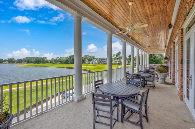 view of patio with ceiling fan and a water view