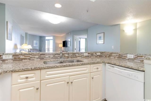 kitchen with white cabinets, sink, white dishwasher, and a textured ceiling