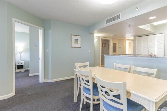 dining area with dark carpet