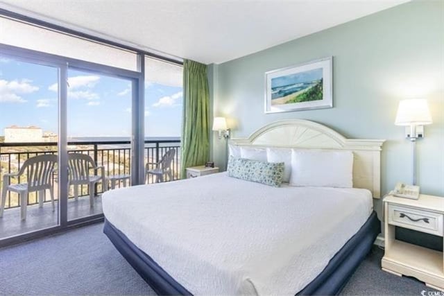 bedroom with expansive windows and dark carpet