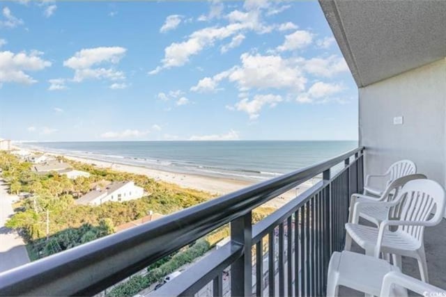 balcony featuring a view of the beach and a water view