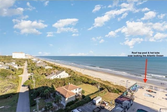 bird's eye view with a water view and a beach view