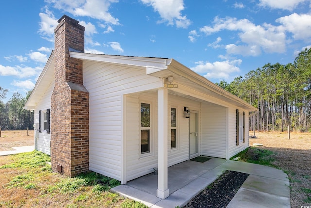 view of side of home with a patio