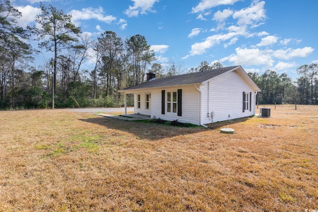 view of home's exterior featuring a lawn and central AC unit