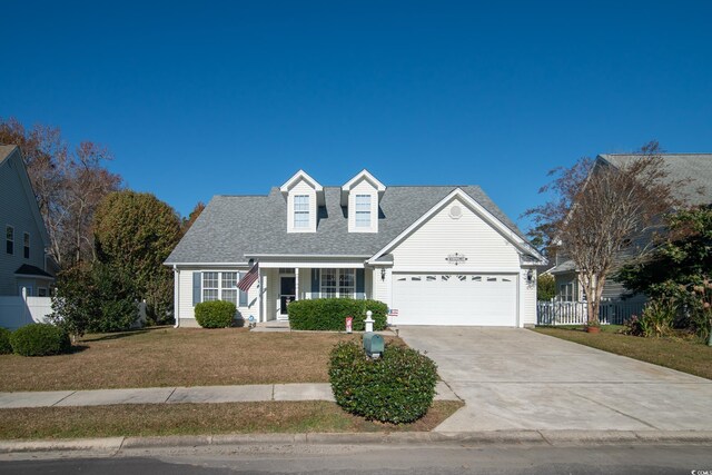 cape cod home with a porch, a garage, and a front lawn