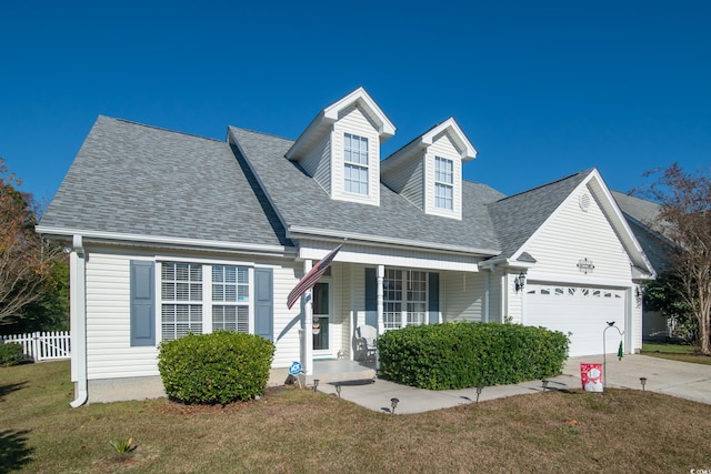 cape cod house with covered porch, a garage, and a front yard