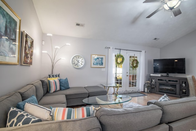 living room featuring french doors, ceiling fan, lofted ceiling, and hardwood / wood-style floors