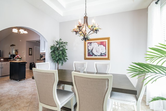 tiled dining room featuring an inviting chandelier