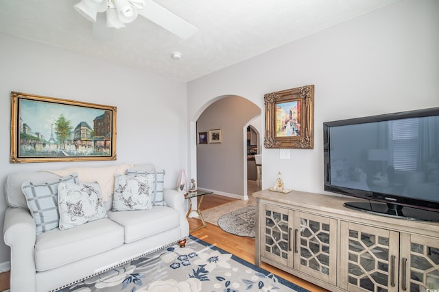 living room with ceiling fan and hardwood / wood-style floors