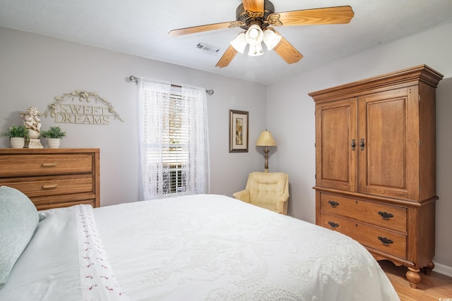 bedroom with wood-type flooring and ceiling fan