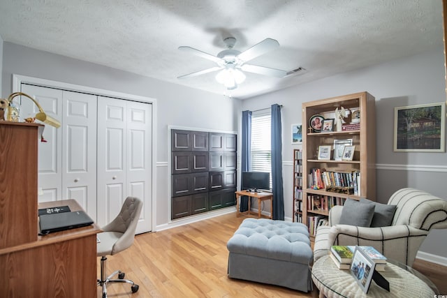 office area with hardwood / wood-style floors, a textured ceiling, and ceiling fan