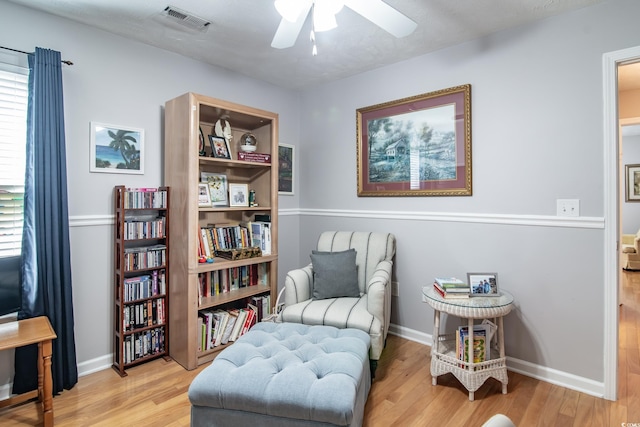 living area with ceiling fan and light hardwood / wood-style flooring