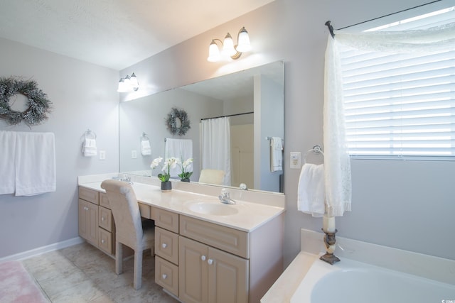 bathroom with a textured ceiling, vanity, and a tub