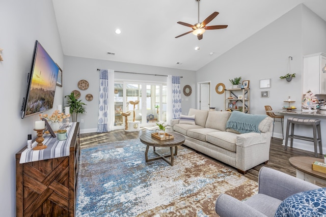 living room with ceiling fan, dark hardwood / wood-style flooring, and high vaulted ceiling