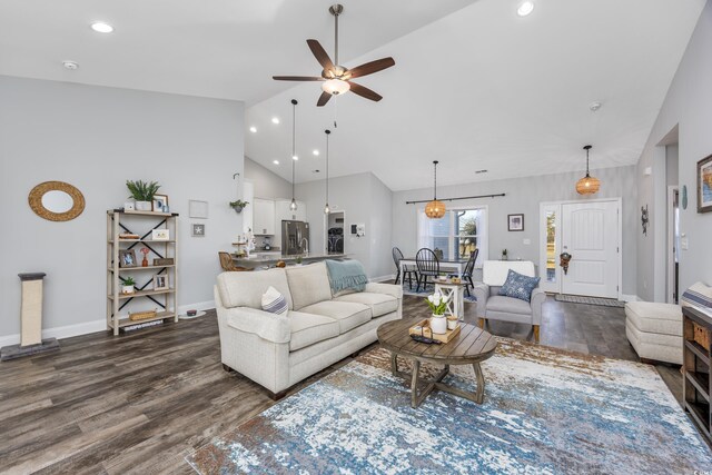 living room with dark hardwood / wood-style floors, high vaulted ceiling, and ceiling fan