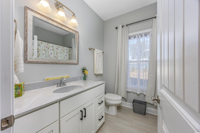 bathroom featuring tile patterned floors, vanity, and toilet