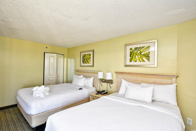 bedroom with a textured ceiling and a closet