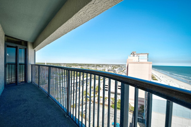 balcony with a water view and a beach view