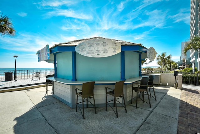 view of patio / terrace with a bar and a water view