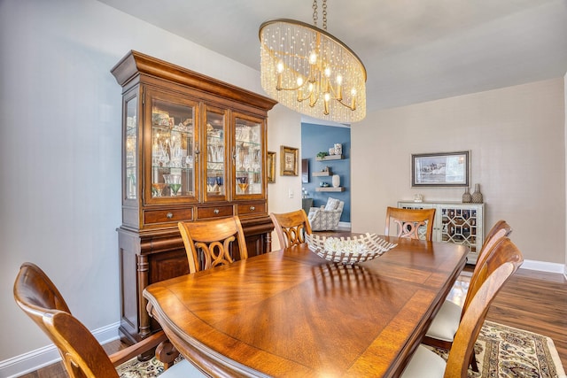 dining room featuring dark hardwood / wood-style floors and a notable chandelier