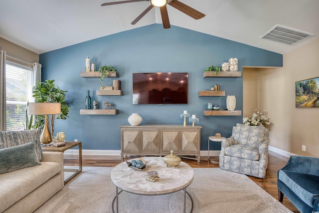 living room featuring lofted ceiling with beams, ceiling fan, and wood-type flooring