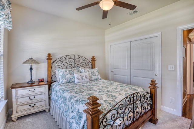 carpeted bedroom featuring a closet and ceiling fan