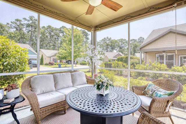 sunroom / solarium featuring ceiling fan