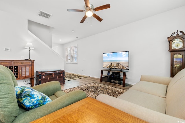 living room with hardwood / wood-style flooring and ceiling fan