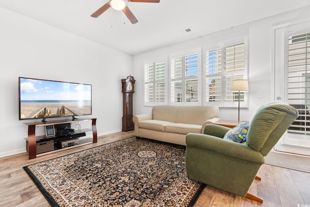 living room featuring ceiling fan and wood-type flooring