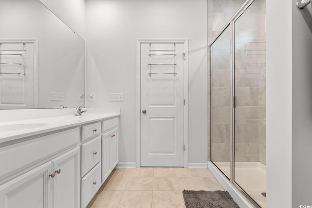 bathroom with tile patterned floors, vanity, and an enclosed shower