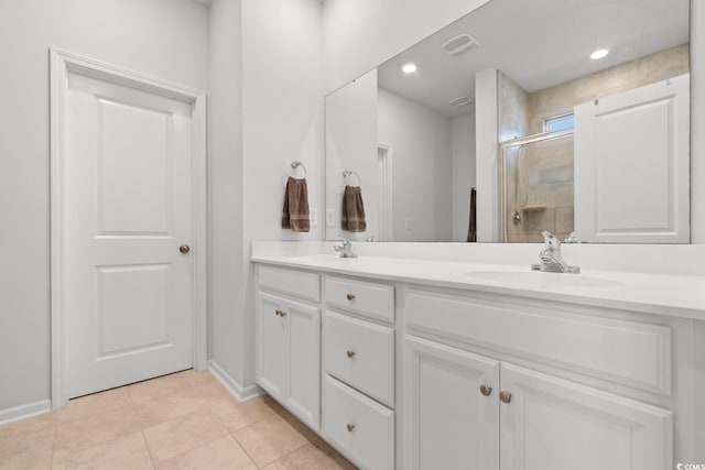 bathroom featuring tile patterned flooring, vanity, and walk in shower