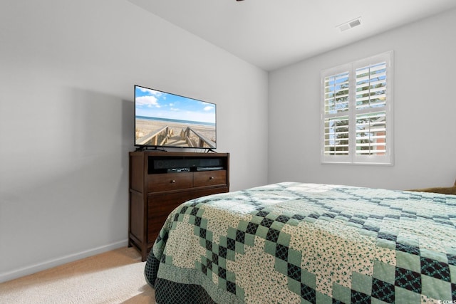 bedroom featuring light carpet