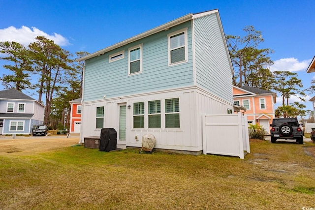 back of house with a lawn